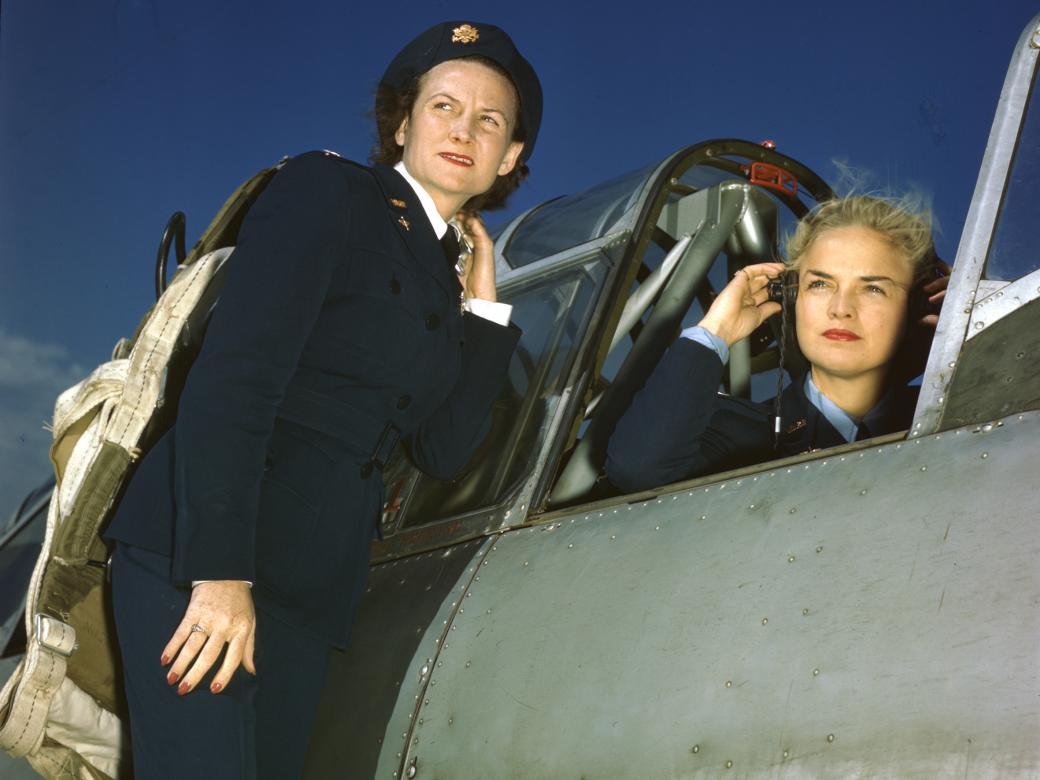 WASP Ann McClellan adjusts her earphones in the cockpit of a BT-13