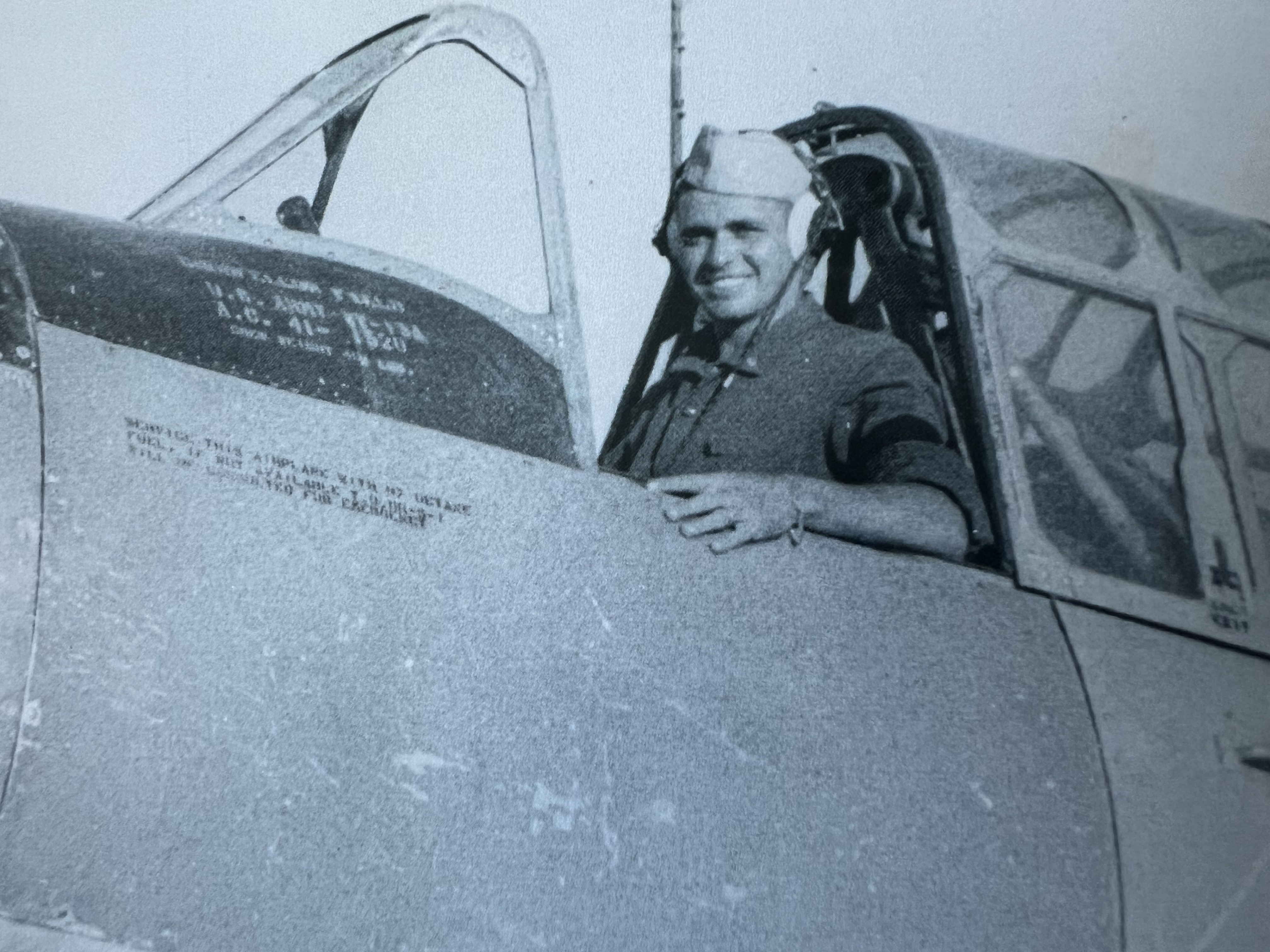 A black and white photo of Daniel Eyles in the flight deck of a plane.
