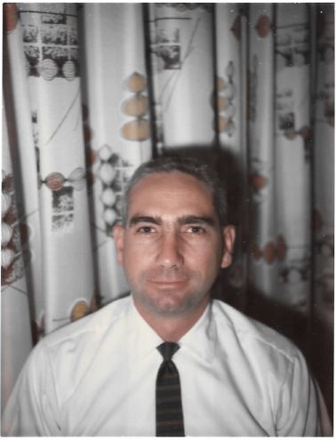 Robert William Goddard Sr. in a white shirt and black tie.