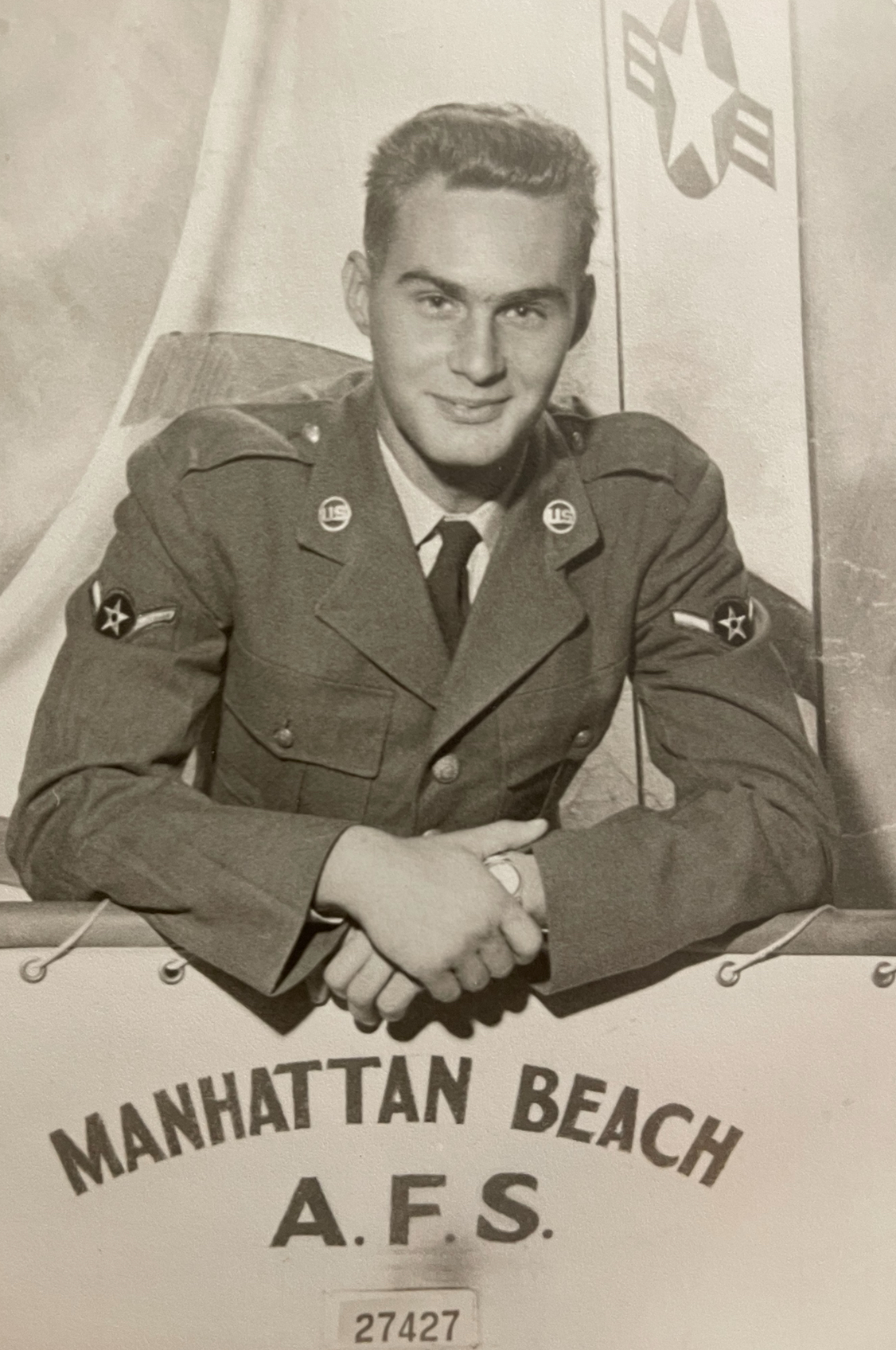 A black and white photo of Thomas Mace in uniform above a banner reading 'Manhattan Beach A.F.S''