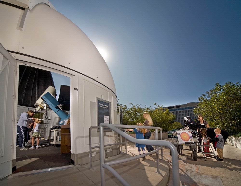 At the National Air and Space Museum's public observatory, visitors can look through the 16-inch telescope to discover craters on the Moon, spots on the Sun (using safe solar filters), and other wonders of the Universe. Credit: Photo by Eric Long, National Air and Space Museum, Smithsonian Institution